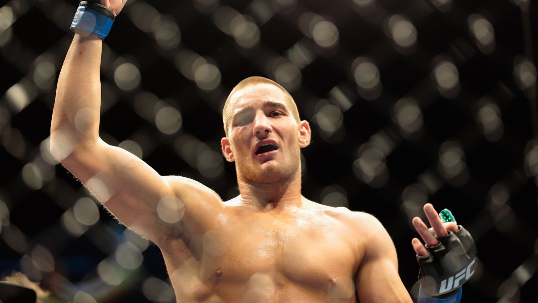 Sean Strickland from the United States shows his hands after he beats Luke Barnatt, left, from Great Britain.