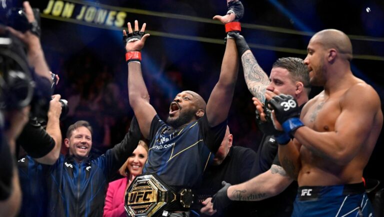 Jon Jones, center, celebrates after defeating Ciryl Gane in a UFC 285 mixed martial arts heavyweight title bout.