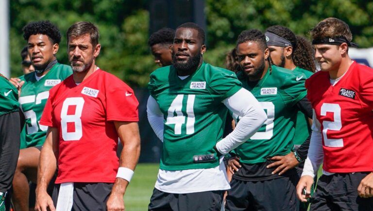 New York Jets quarterback Aaron Rodgers (8) warms up during practice at the NFL football team's training facility, Friday, July 21, 2023, in Florham Park, N.J. (AP Photo/John Minchillo)