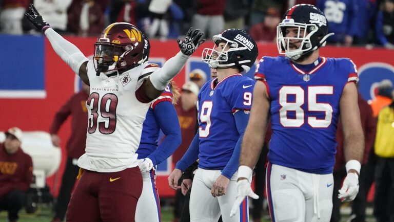 New York Giants kicker Graham Gano, center, looks after his field goal during overtime of an NFL football game against the Washington Commanders, Sunday, Dec. 4, 2022, in East Rutherford, N.J. The kick missed and the game ended in a tie.
