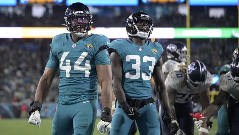 Jacksonville Jaguars linebacker Travon Walker (44) and linebacker Devin Lloyd (33) react after a play during the second half of an NFL football game against the Tennessee Titans, Saturday, Jan. 7, 2023, in Jacksonville, Fla.