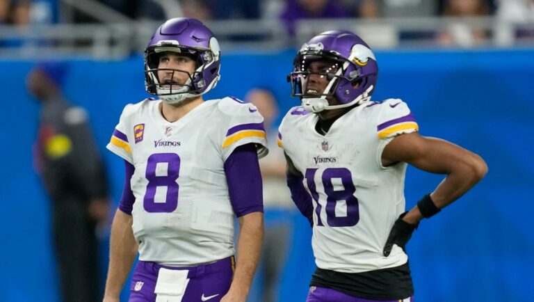 Minnesota Vikings' Kirk Cousins and Justin Jefferson watch a replay during the second half of an NFL football game against the Detroit Lions Sunday, Dec. 11, 2022, in Detroit. (AP Photo/Paul Sancya)
