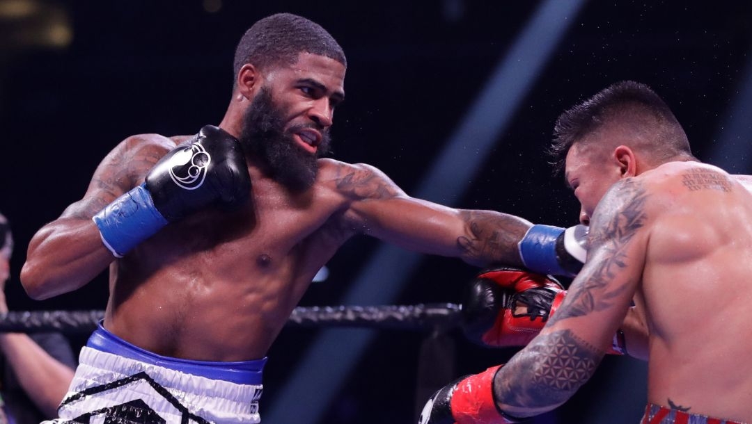 Stephen Fulton, left, punches Ukraine's Arnold Khegai during the seventh round.