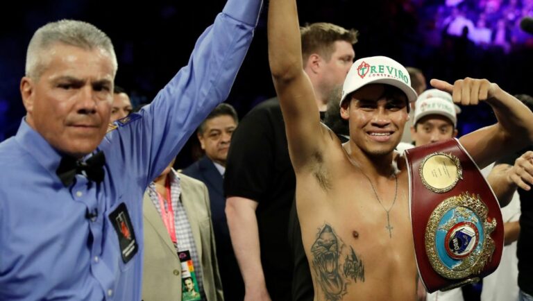 Emanuel Navarrete, right, of Mexico, celebrates after defeating Juan Miguel Elorde, of the Philippines, in their boxing match.