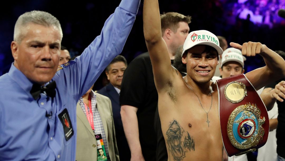 Emanuel Navarrete, right, of Mexico, celebrates after defeating Juan Miguel Elorde, of the Philippines, in their boxing match.