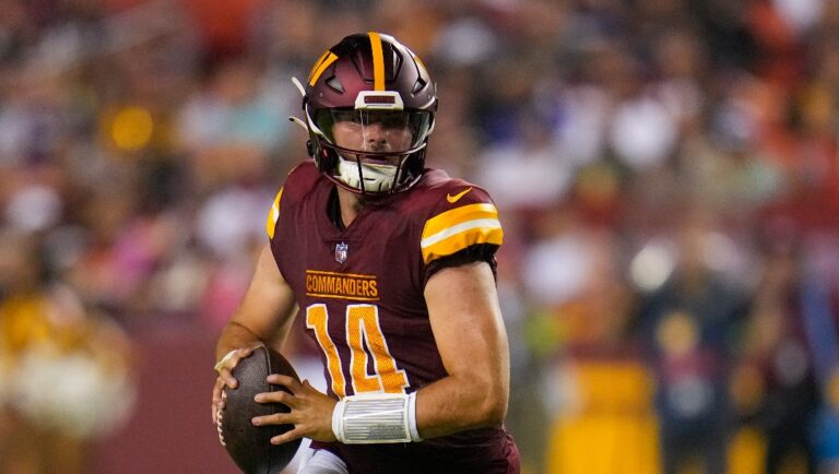 Washington Commanders quarterback Sam Howell scrambles during the first half of an NFL preseason football game against the Baltimore Ravens, Monday, Aug. 21, 2023, in Landover, Md. (AP Photo/Julio Cortez)