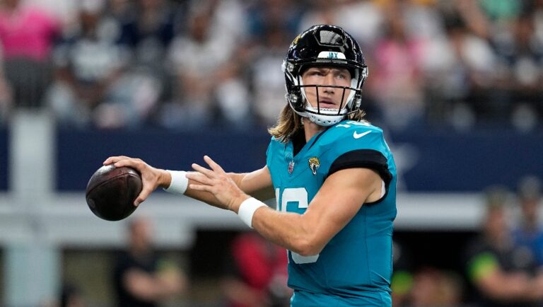 Jacksonville Jaguars quarterback Trevor Lawrence drops back to pass during a presesaon NFL football game against the Dallas Cowboys in Arlington, Texas, Saturday, Aug. 12, 2022.