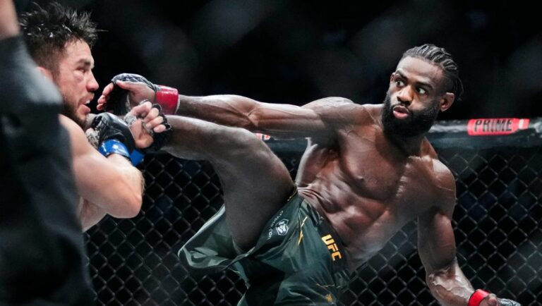 Aljamain Sterling, of Jamaica, kicks Henry Cejudo during the fifth round of a bantamweight title bout at the UFC 288.