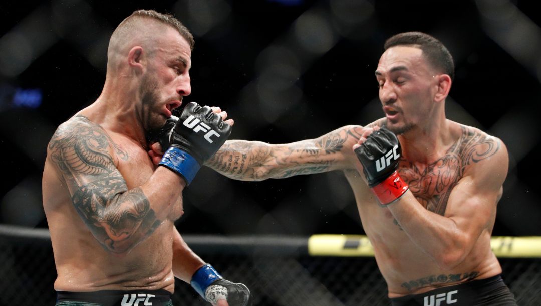 Max Holloway hits Alexander Volkanovski in a mixed martial arts featherweight championship bout at UFC 245.