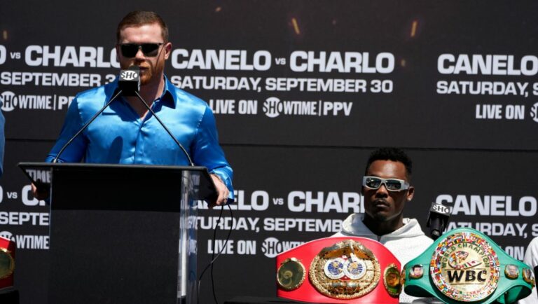 Undisputed super middleweight world champion Canelo Álvarez, left, of Mexico, speaks during a boxing news conference.