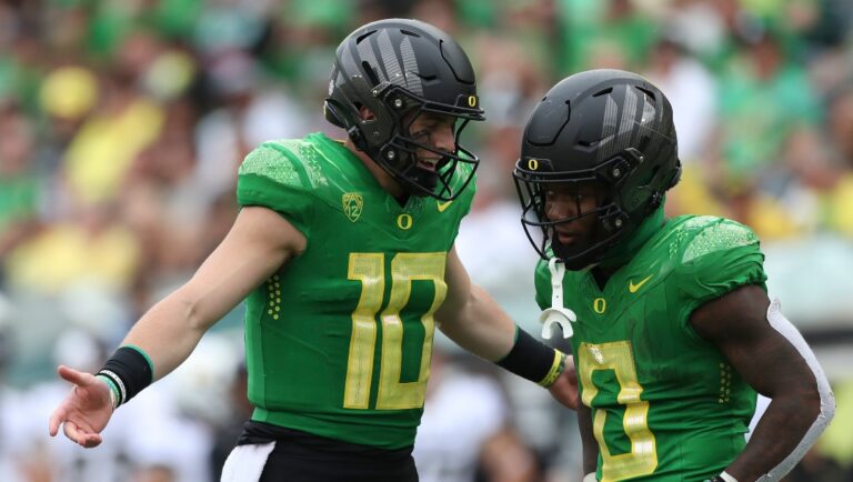 Oregon quarterback Bo Nix (10) talks with running back Bucky Irving (0) during an NCAA football game against Colorado, Saturday, Sept. 23, 2023, in Eugene, Ore. Oregon won 42-6. (AP Photo/Amanda Loman)