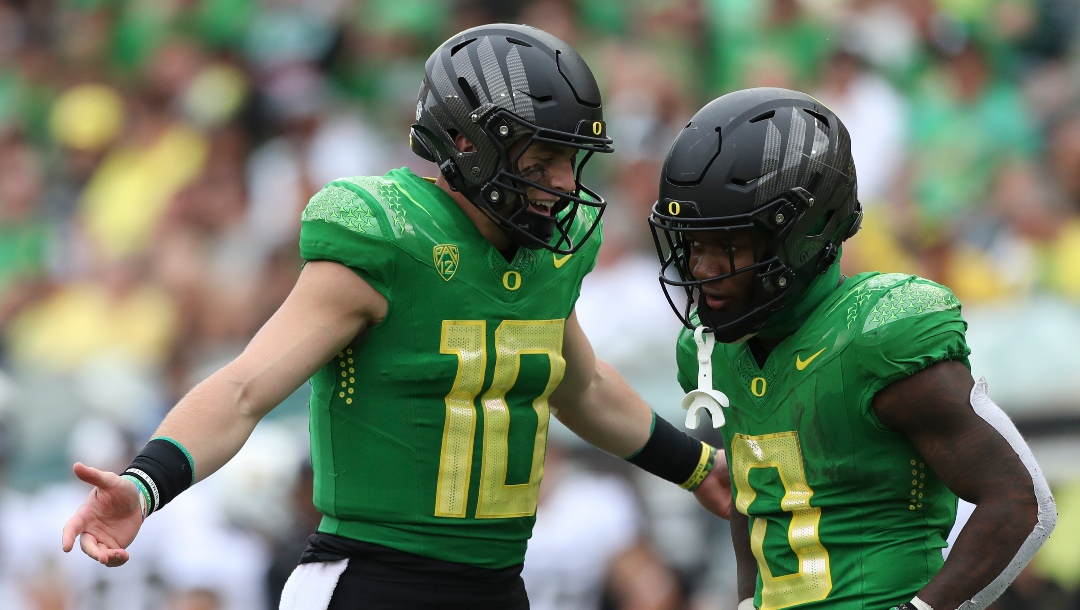 Oregon quarterback Bo Nix (10) talks with running back Bucky Irving (0) during an NCAA football game against Colorado, Saturday, Sept. 23, 2023, in Eugene, Ore. Oregon won 42-6. (AP Photo/Amanda Loman)