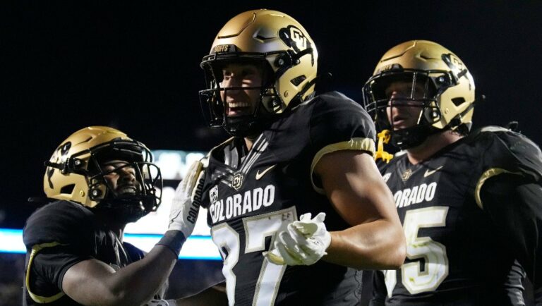 Colorado tight end Michael Harrison, center, celebrates after his touchdown catch with running back Dylan Edwards, left, and guard Jack Bailey in the second overtime of an NCAA college football game against Colorado State Saturday, Sept. 16, 2023, in Boulder, Colo. (AP Photo/David Zalubowski)