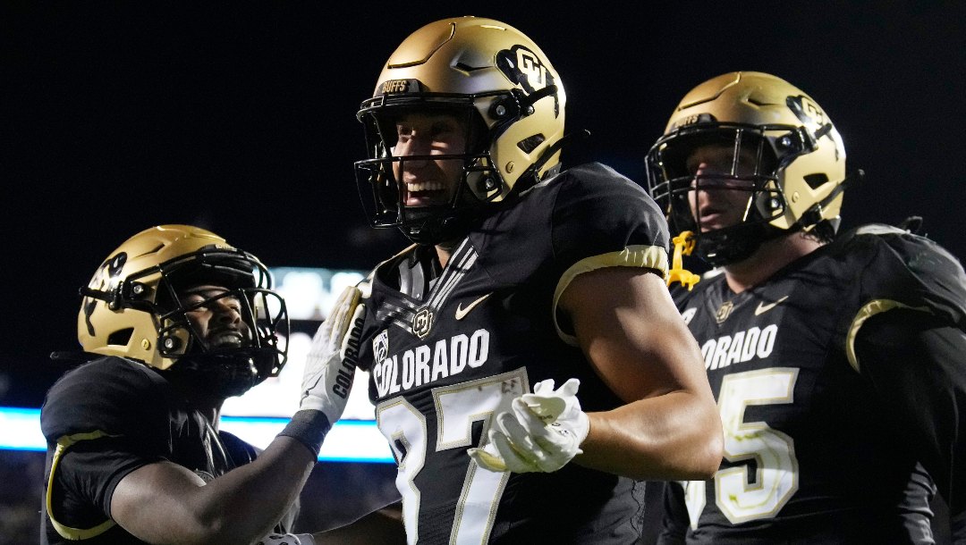 Colorado tight end Michael Harrison, center, celebrates after his touchdown catch with running back Dylan Edwards, left, and guard Jack Bailey in the second overtime of an NCAA college football game against Colorado State Saturday, Sept. 16, 2023, in Boulder, Colo. (AP Photo/David Zalubowski)