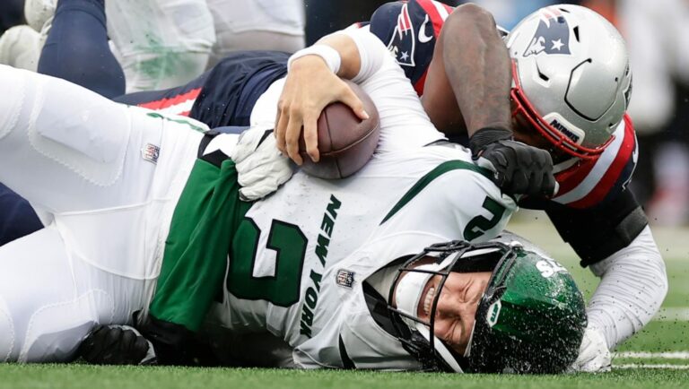 New York Jets quarterback Zach Wilson (2) is sacked by the New England Patriots during an NFL football game, Sunday, Sept. 24, 2023, in East Rutherford, N.J.