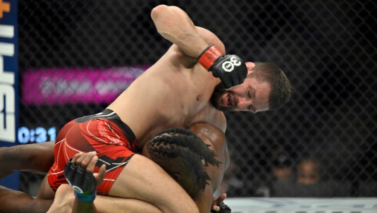 Mateusz Gamrot, top, punches Jalin Turner during a UFC 285 mixed martial arts lightweight bout Saturday, March 4, 2023.