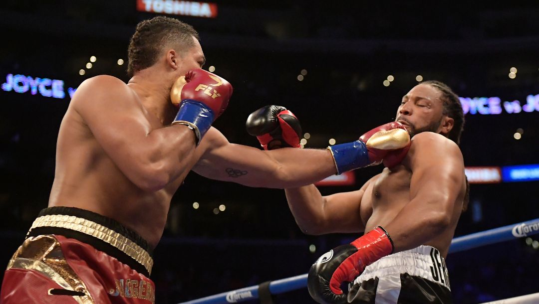 Joe Joyce, left, of England, connects with a left to Joe Hanks during a WBA continental heavyweight boxing bout Saturday.