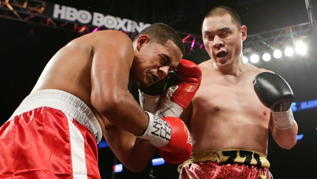Zhang Zhilei,right, of China, punches Glen Thomas during the third round of a boxing match Saturday, June 6, 2015, in New York.