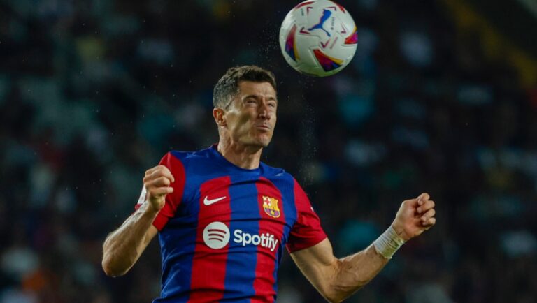 Barcelona's Robert Lewandowski heads the ball during a Spanish La Liga soccer match between Barcelona and Sevilla, at the Olympic Stadium of Montjuic in Barcelona, Spain, Friday, Sept. 29, 2023.