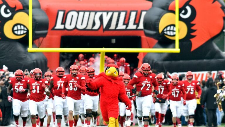 Louisville players run onto the field before an NCAA college football game against Kentucky, Saturday, Nov. 26, 2016, in Louisville, Ky.