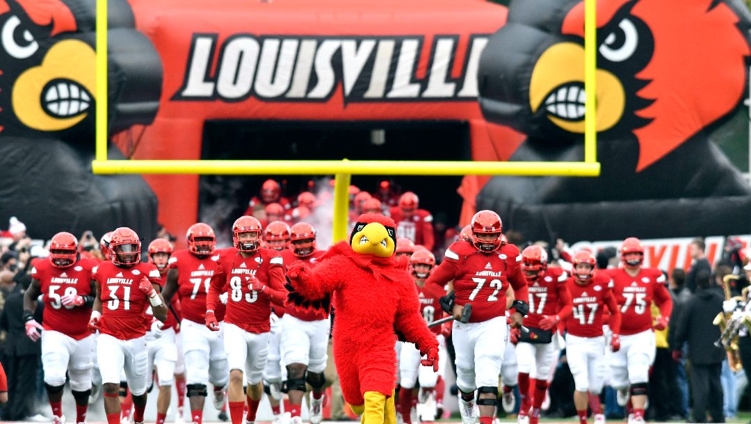 Louisville players run onto the field before an NCAA college football game against Kentucky, Saturday, Nov. 26, 2016, in Louisville, Ky.
