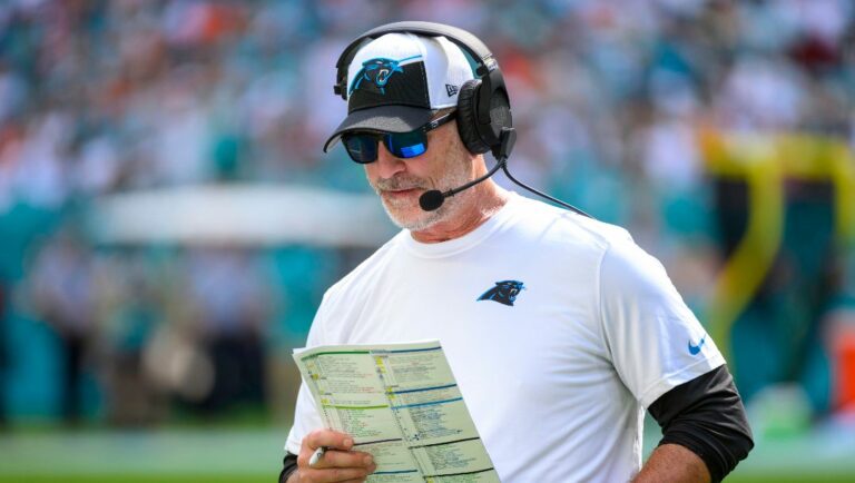 Carolina Panthers head coach Frank Reich looks at his play sheet on the sidelines during an NFL football game against and the Miami Dolphins, Sunday, Oct. 15, 2023, in Miami Gardens, Fla.