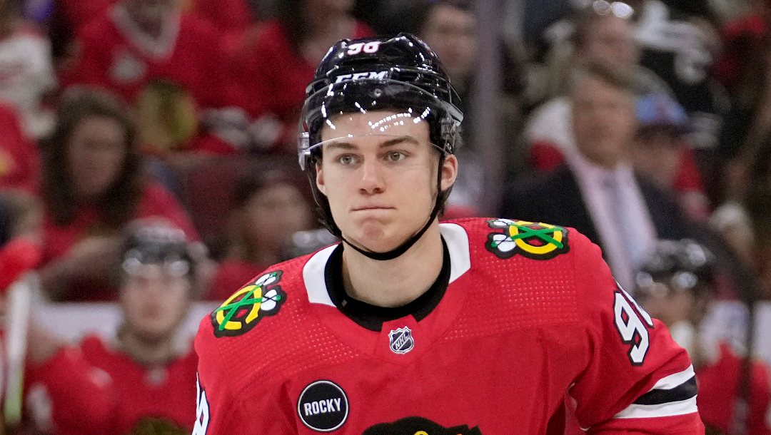 Chicago Blackhawks center Connor Bedard watches his teammates during the first period of an NHL preseason hockey game against the Detroit Red Wings, Oct. 3, 2023, in Chicago. Bedard, the 18-year-old top pick by the Blackhawks, makes his NHL debut on Tuesday, Oct. 10 when he faces Pittsburgh Penguins and star center Sidney Crosby, a top pick himself 17 years ago.