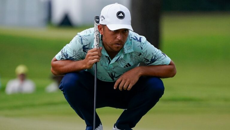Xander Schauffele lines up a putt on the fifth green during the third round of the Tour Championship golf tournament, Sunday, Aug. 27, 2023, in Atlanta.