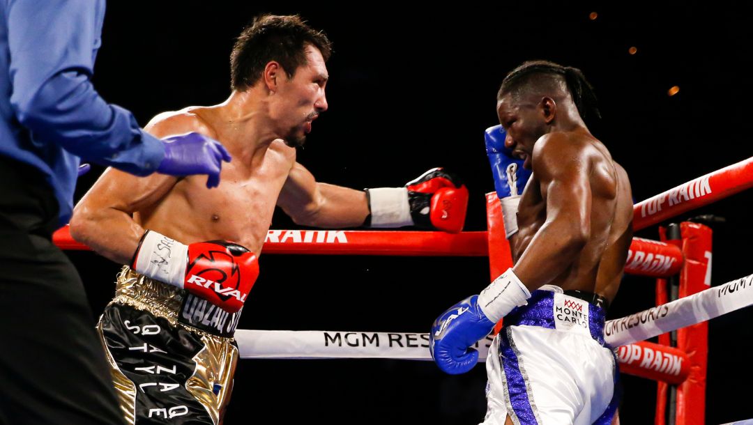 Janibek Alimkhanuly, of Kazakhstan, left, fights Hassan N'Dam N'Jikam, of Cameroon, during a middleweight boxing match.