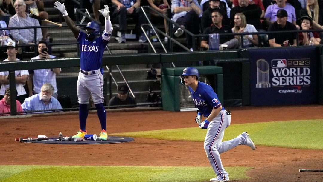 Texas Rangers' Corey Seager, right, watches his two-run home run as Adolis Garcia, left, reacts during the third inning in Game 3 of the baseball World Series against the Arizona Diamondbacks Monday, Oct. 30, 2023, in Phoenix.
