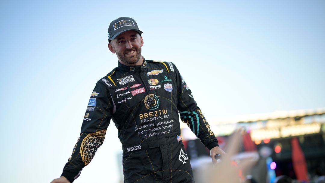Austin Dillon slaps hands with spectators during driver introductions before a NASCAR Cup Series auto race at Daytona International Speedway, Saturday, Aug. 26, 2023, in Daytona Beach, Fla.