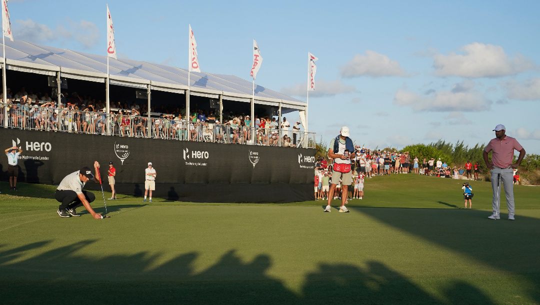 Viktor Hovland, of Norway, left, lines up a putt on the 18th green during the final round of the Hero World Challenge PGA Tour at the Albany Golf Club, in New Providence, Bahamas, Sunday, Dec. 4, 2022.