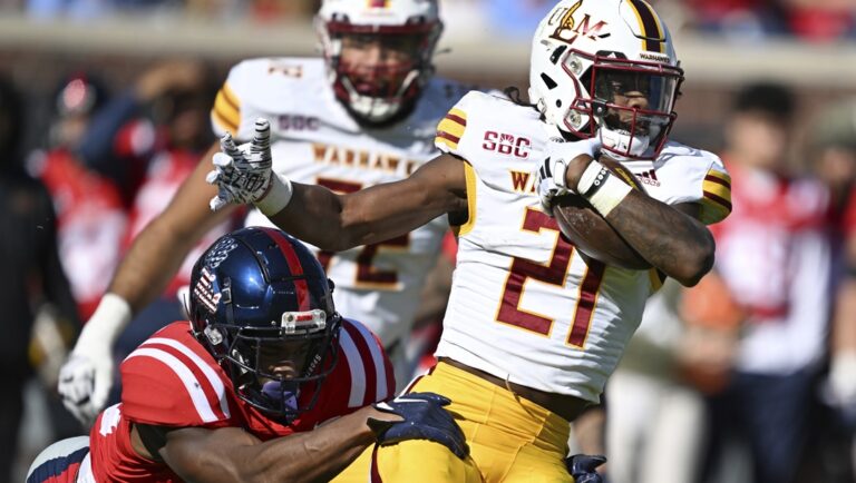 Mississippi safety Trey Washington (25) tackles Louisiana Monroe running back Hunter Smith (21) during the first half of an NCAA college football game in Oxford, Miss., Saturday, Nov. 18, 2023.