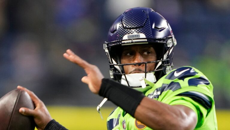 Seattle Seahawks quarterback Geno Smith warms up before an NFL football game against the San Francisco 49ers, Thursday, Nov. 23, 2023, in Seattle. (AP Photo/Lindsey Wasson)