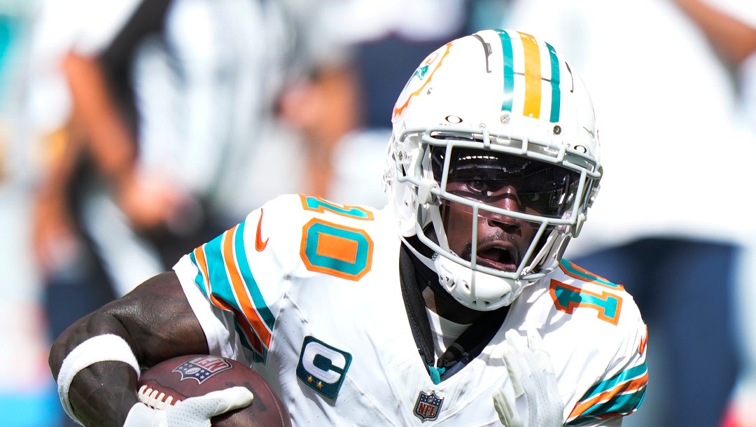 Miami Dolphins wide receiver Tyreek Hill runs for yardage during the first half of an NFL football game against the New England Patriots, Sunday, Oct. 29, 2023, in Miami Gardens, Fla. (AP Photo/Wilfredo Lee)