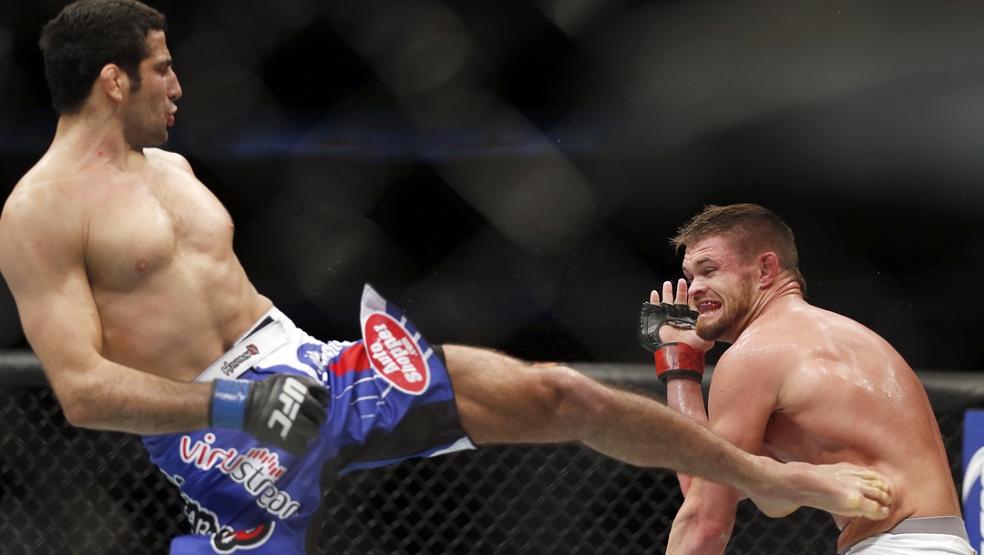 Beneil Dariush, left, and Daron Cruickshank fight during a men's lightweight UFC bout, Saturday, March 14, 2015, in Dallas.