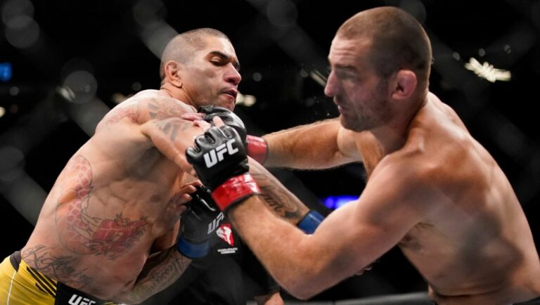 Alex Pereira, left, fights Sean Strickland in a middleweight bout during the UFC 276 mixed martial arts event.