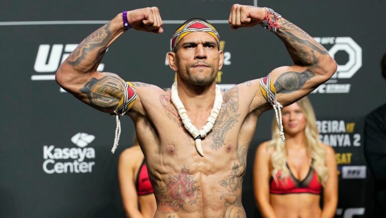 UFC 287 middleweight champion Alex Pereira raises his fists during a ceremonial weigh-in Friday, April 7, 2023, in Miami.