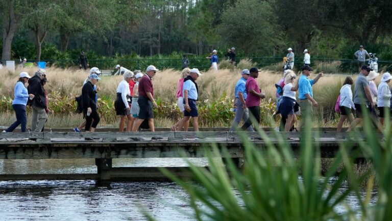 Fans walk on a bridge during the second round of the LPGA CME Group Tour Championship golf tournament, Friday, Nov. 18, 2022, at the Tiburón Golf Club in Naples, Fla.