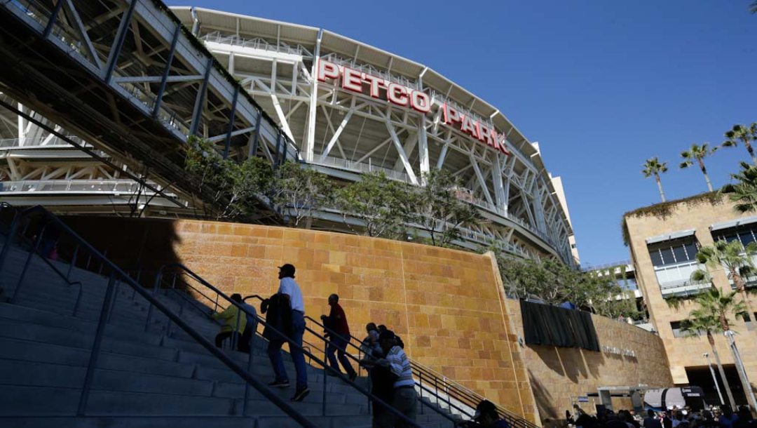 Fans arrive before an opening day baseball game between the Los Angeles Dodgers and the San Diego Padres on Sunday, March 30, 2014, in San Diego.