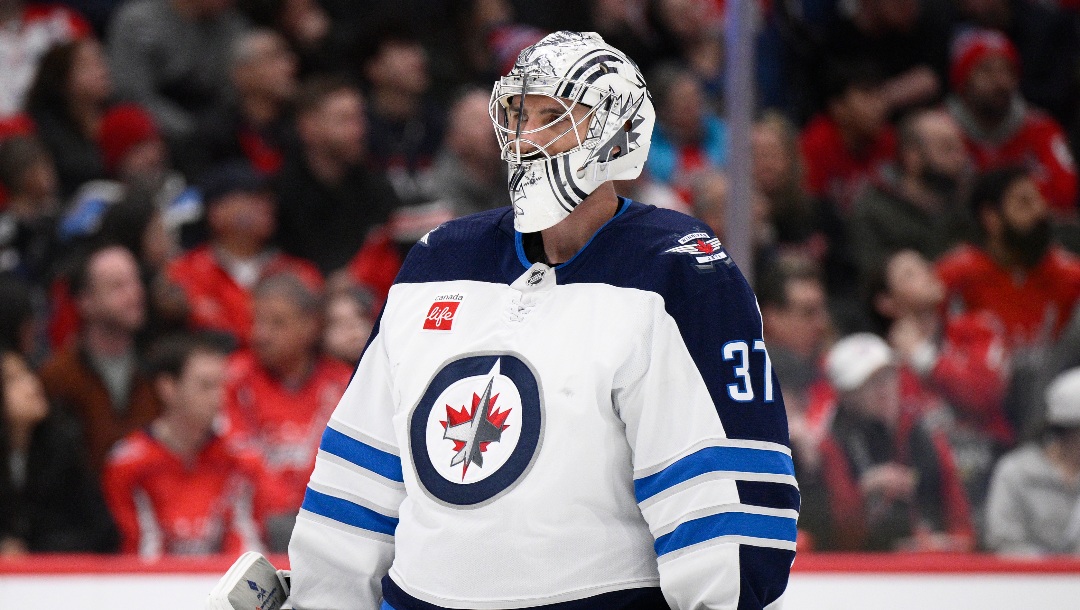 Winnipeg Jets goaltender Connor Hellebuyck (37) looks on during the first period of an NHL hockey game against the Washington Capitals, Saturday, Feb. 1, 2025, in Washington. (AP Photo/Nick Wass)