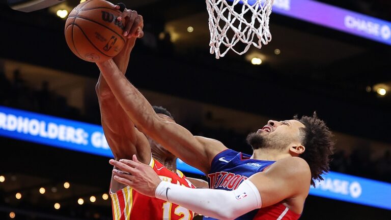 De'Andre Hunter #12 of the Atlanta Hawks blocks a shot attempt against Cade Cunningham #2 of the Detroit Pistons during the fourth quarter at State Farm Arena on December 18, 2023 in Atlanta, Georgia.