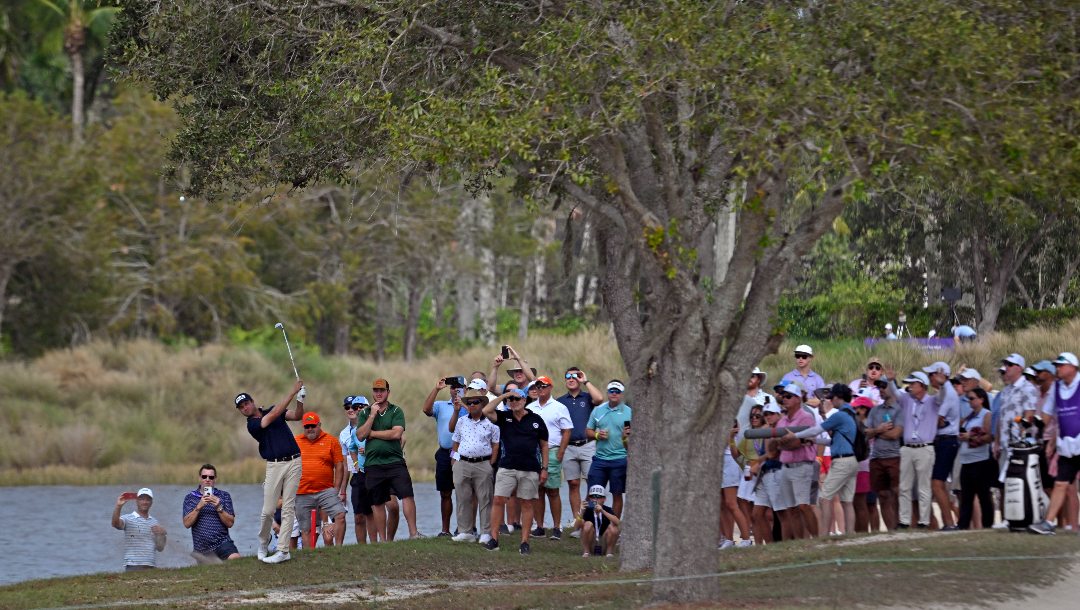 Harris English hits from the rough to the ninth green during the final round of the Grant Thornton Invitational, the first mixed-team golf tournament since 1999, Sunday, Dec. 10, 2023, in Naples, Fla.