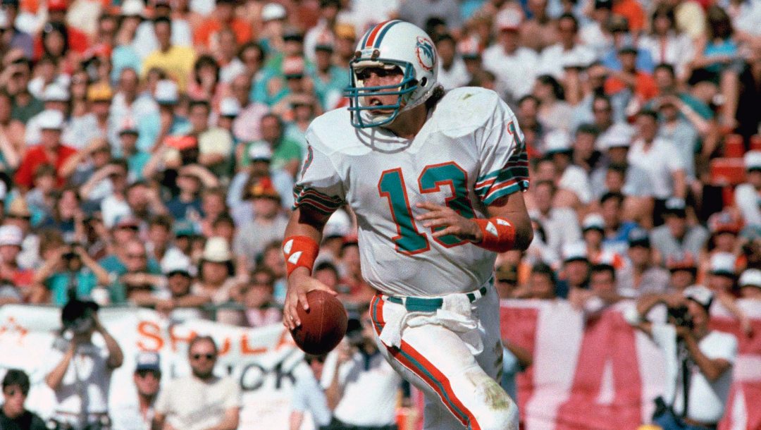 In this Jan. 20, 1985, file photo, Miami Dolphins quarterback Dan Marino scrambles during NFL football's Super Bowl XIX, against the San Francisco 49ers in Palo Alto, Calif.