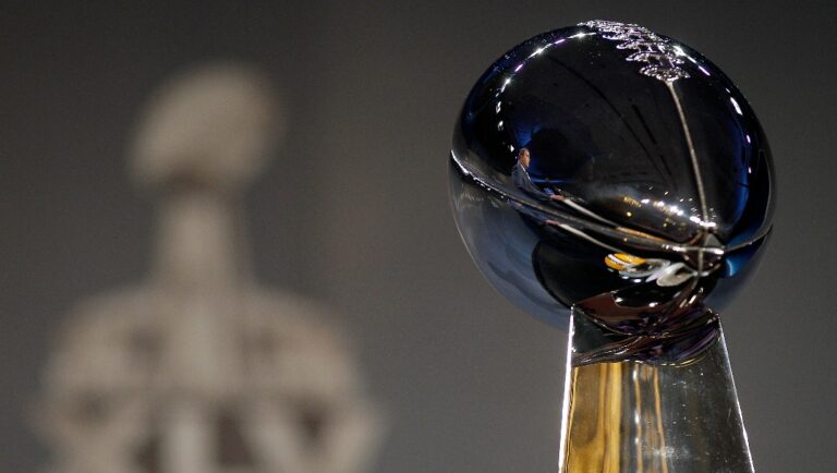 Green Bay Packers head coach Mike McCarthy is reflected in the Vince Lombardi Trophy as he answers questions during a news conference at the NFL football Super Bowl XLV Media Center in Dallas, Friday, Feb. 4, 2011. The Packers will face the Pittsburgh Steelers in Super Bowl XLV Sunday. (AP Photo/Matt Slocum)