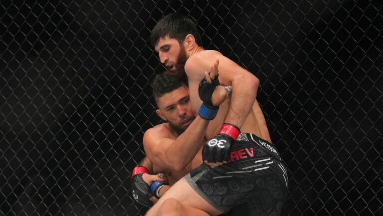 Magomed Ankalaev of Russia, right, battles Johnny Walker of Brazil in a light heavyweight fight during the UFC 294 event.