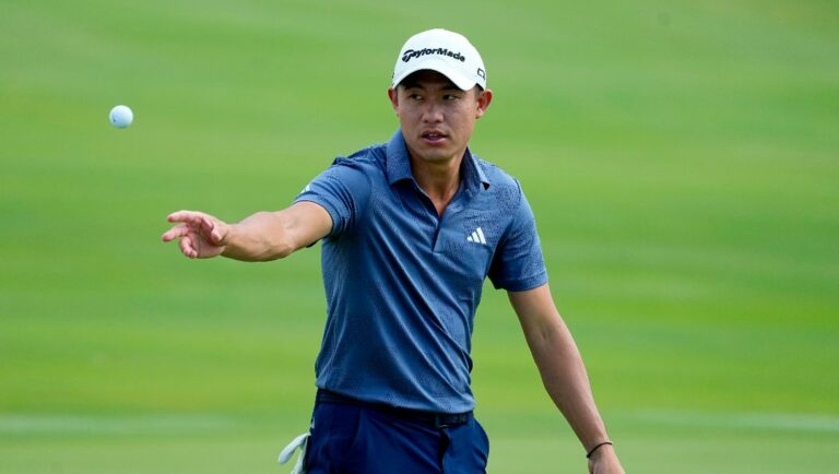 Collin Morikawa tosses his ball to his caddy on the 18th green during the first round of The Sentry golf event, Thursday, Jan. 4, 2024, at Kapalua Plantation Course in Kapalua, Hawaii.