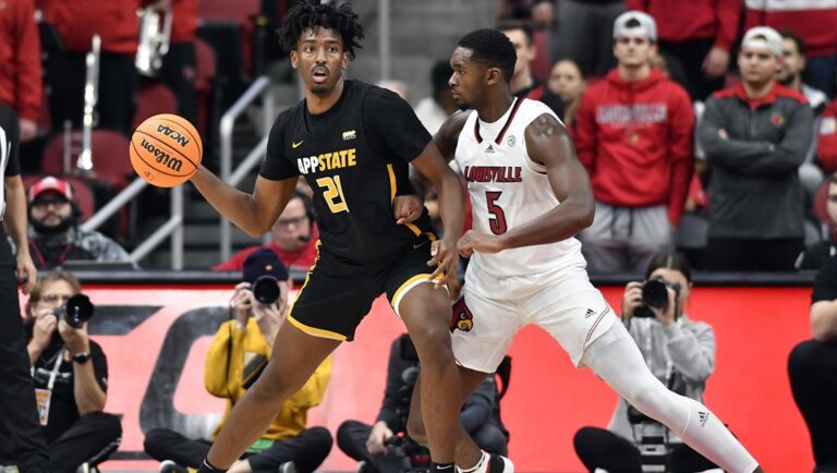 Appalachian State forward Justin Abson (21) looks for help from the defense of Louisville forward Brandon Huntley-Hatfield (5) during the second half of an NCAA college basketball game in Louisville, Ky., Tuesday, Nov. 15, 2022. Appalachian St. won 61-60.