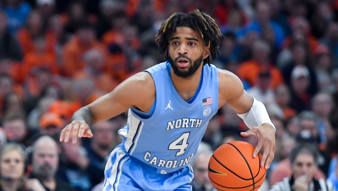 North Carolina guard RJ Davis (4) handles the ball during the first half of an NCAA college basketball game against Syracuse in Syracuse, N.Y., Tuesday, Feb. 13, 2024. (AP Photo/Adrian Kraus)