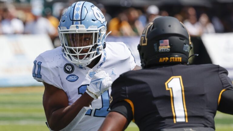 North Carolina Tar Heels linebacker Raneiria Dillworth (11) runs kick coverage against Appalachian State defensive back Kaleb Dawson (2) during the second half of an NCAA college football game, Saturday Sept. 3, 2022, in Boone, N.C.